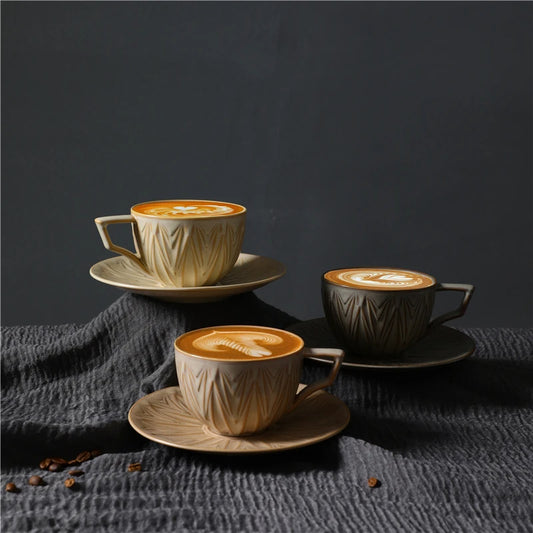 Filiżanki Nova z kawą i latte art, ustawione na dopasowanych spodkach