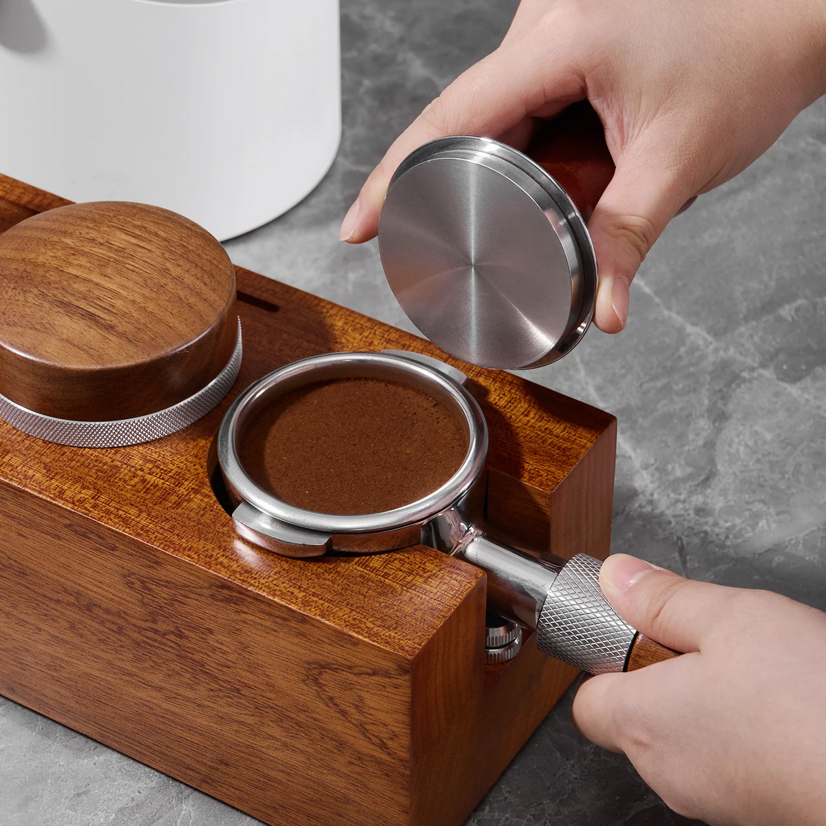 Portafilter z kawą oparty na stacji Barista Dock podczas podnoszenia dystrybutora